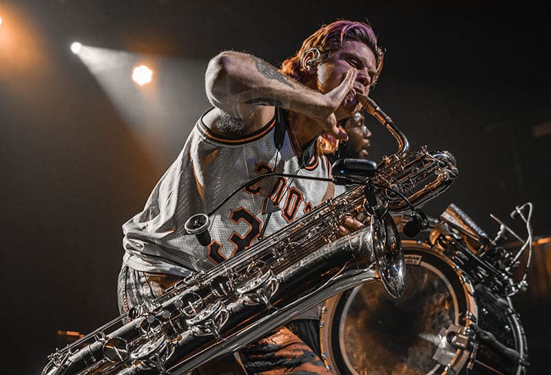 Leo P playing saxophone on stage